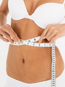 Young Woman Measuring Waist